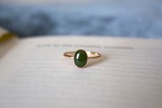 STUNNING 14k gold filled or Sterling Silver handmade Nephrite Jade ring ✨ * Listing covers the single Nephrite Jade ring, other rings shown are sold separately.   Beautiful 8x6mm natural oval olive green Jade gemstone✨⚒️  Jade is a special stone that is believed to promote wisdom, balance, and peace. Jade has a history that traces back to prehistoric times, to the ancient Chinese, the Maori, and to the Aztecs and Inca peoples of Central America.  Reputed by folklore to attract love, this stone was also believed to deliver prosperity and power to those who wore or carried it. * Please note photos are zoomed in up close, therefore the size of the stone may appear slightly larger in photos. Model is wearing a size US 5.5. Please refer to stone measurement to best determine the size & look you Jade Gold Ring, The Aztecs, Gifts For My Girlfriend, Attract Love, Jade Gemstone, Nephrite Jade, Jade Ring, Ring Minimalist, Minimalist Ring