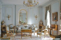 an ornately decorated living room with blue walls