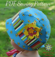 a young child wearing a blue hat with flowers on it's brim and the words pdf sewing pattern