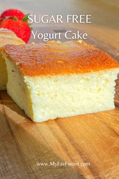 a slice of sugar free yogurt cake on a cutting board next to a strawberry