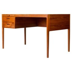 a wooden desk with two drawers on one side and an open drawer on the other