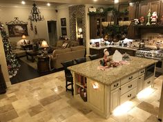 a kitchen and living room are decorated for the holiday season with christmas decorations on the counter