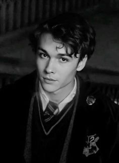 black and white photograph of a young man wearing a harry potter sweater with his eyes closed