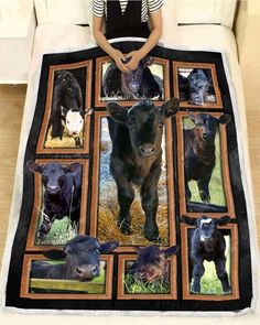 a woman sitting on top of a bed next to a black cow and other cows