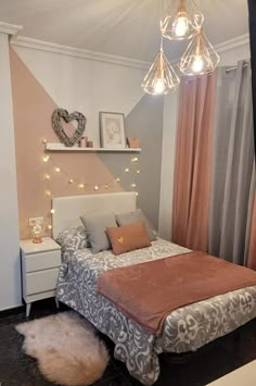 a bed room with a neatly made bed and some lights hanging from the headboard