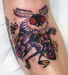 a tattoo on the leg of a person with an owl