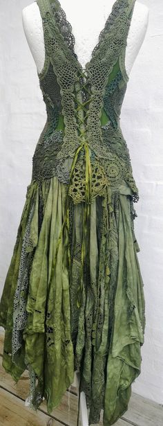 a dress made out of green fabric on a mannequin