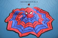 a spiderman crocheted afghan with the words memood dolls on it