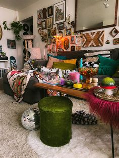 a living room filled with lots of furniture and pictures on the wall above it's coffee table