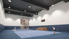 two people playing tennis on an indoor court with blue and white walls, while another person watches from the sidelines