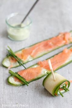 cucumber wrapped in fish and garnished with toothpicks on a table