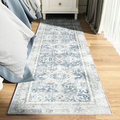 a blue and white area rug in a bedroom