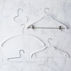 two white hangers on a marble surface