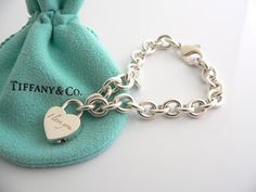 Offered for sale is a wonderful and rare Tiffany and Co. Sterling Silver "I Love You" Heart Padlock bracelet.   The piece is made from substantial and bright Tiffany silver, and yet retains a very feminine feel to it.  Attached to its very substantial Tiffany Silver charm bracelet is a Heart padlock charm with "I Love You" engraved on it.  The"I Love You" padlock charm opens and closes and thus can be used as a charm on a necklace or as part of another charm bracelet! Super versatile piece!  It Luxury Sterling Silver Heart Bracelet For Gift, Luxury Sterling Silver Bracelets For Valentine's Day, Luxury Silver Bracelets For Valentine's Day, Luxury Wedding Heart Bracelet With Heart Charm, Luxury Sterling Silver Heart Bracelet For Valentine's Day, Luxury Heart Charm Bracelet Gift, Lock Bracelet Jewelry Gift, Luxury Valentine's Day Charm Bracelet, Luxury Heart Charm Bracelet For Anniversary