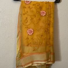 Beautiful Mustard Organza Saree. Floral Embroidery Throughout With Gold Border. Perfect For Any Occasion! Unworn And Brand New. Can Be Worn With Burgundy Or Gold Blouse For Two Completely Different Looks! Silk Dupatta With Chikankari Embroidery, Yellow Silk Salwar Kameez With Chikankari Embroidery, Yellow Silk Churidar With Chikankari Embroidery, Transitional Organza Saree With Dori Work, Transitional Organza Traditional Wear With Dori Work, Chikankari Embroidery Dupatta In Tissue Silk, Orange Resham Embroidery Dupatta, Orange Saree With Dori Work, Chanderi Dupatta With Floral Embroidery