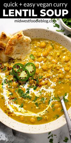 a white bowl filled with lentula soup and topped with bread