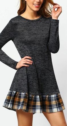 a young woman posing for the camera wearing a plaid skirt and long sleeved top