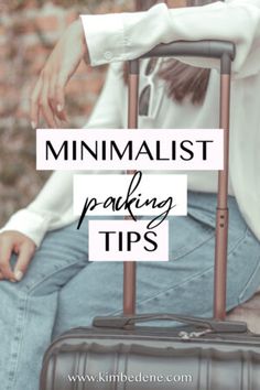 a woman sitting on top of a suitcase with the words minimalist packing tips in front of her