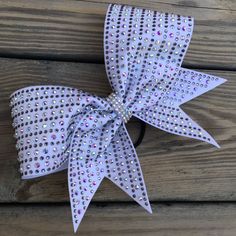 "Our bows are very durable and are made from quality products. Cheer bows are made with grosgrain ribbon and specialty fabrics. We also offer vinyl, glitter, rhinestones, sublimation, and sequins all in a variety of colors to customize your individual bow or team bow. Note: Actual fabric colors may vary from the screens of electronic devices. Bow sizes for standard cheer bows are approximately 7\"x8\" and for tailless bows 4\"x6\", unless otherwise specified. Custom sizing is available. Contact Cheer Stuff, Handmade Gift Wrap, Electronic Devices, Dance Outfits