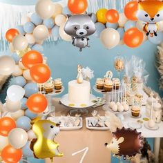 an animal themed birthday party with balloons and desserts