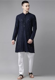 Rayon Kurta in Navy Blue This Readymade Chinese Collar Neck and Full Sleeve attire is Enhanced with Resham and Sequins Work Available with a Poly Cotton Pajama in White Do note: Footwear shown in the image is for presentation purposes only. Half to one inch may vary in measurement. (Slight variation in actual color vs. image is possible) Blue Long Sleeve Kurta With Gota Work, Long Sleeve Traditional Wear With Sequins For Navratri, Blue Long Sleeve Set With Gota Work, Blue Traditional Wear With Sequins, Blue Sequined Traditional Wear With Drape, Blue Semi-stitched Traditional Wear With Sequins, Blue Traditional Wear With Sequins For Festivals, Traditional Blue Sequined Sets, Blue Cotton Traditional Wear With Mirror Work