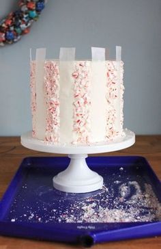 a white cake with red and blue sprinkles sitting on top of a blue tray