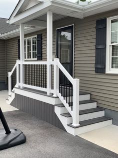 the front porch of a house with steps leading up to it's door and windows