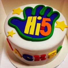 a birthday cake with the number five on it's icing and colorful decorations