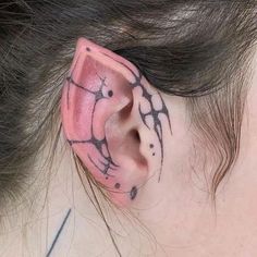 a close up of a person's ear with tattoos on it