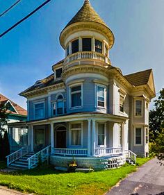 an old victorian style house on the corner of a street