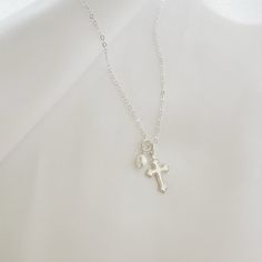 Natural AA freshwater pearl and cross charms strung on dainty signature chain; adjustable. Charms are removable for versatility. Length: 16” + 2” extender Chain: 14k gold filled or sterling silver dainty cable chain with spring clasp. Pearl: 4-5mm Charm: 11mm Always gold filled, never plated. Waterproof and tarnish resistant. Wear with confidence Handmade with the highest standards & quality materials Each natural pearl is unique and therefore no two are alike. Pearls, colors and sizes may vary. Pearls Colors, Cotton Jewelry, Mama Necklace, Cuff Rings, Charm Pendant Necklace, Natural Pearl, Cross Charms, Gold Filled Jewelry, Beauty Accessories