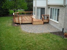 a deck and patio in front of a house