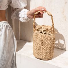 The Buckety collection is a celebration of artistry and sustainable fashion. Both timeless and versatile, the bucket shape makes it suitable for a wide range of occasions! The use of natural raffia, an eco-friendly and renewable material, ensures that this bag is not only a fashion statement but also an eco-conscious choice.  The bag's compact size is perfect for those who appreciate the charm of simplicity. It offers enough space to carry your essentials while maintaining an air of minimalism. Eco-friendly Beige Pouch Bucket Bag, Elegant Natural Color Bucket Bag Tote, Elegant Natural Color Bucket Tote Bag, Elegant Natural Color Tote Bucket Bag, Elegant Everyday Bucket Straw Bag, Elegant Natural Bucket Shoulder Bag, Eco-friendly Cream Bucket Bag, Elegant Natural Color Bucket Shoulder Bag, Elegant Natural Color Shoulder Bucket Bag