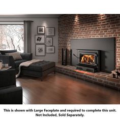 a living room filled with furniture and a fire place next to a brick wall covered in pictures