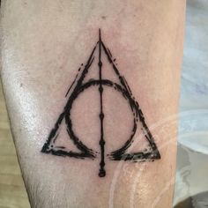 a harry potter symbol tattoo on the leg