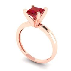 a rose gold ring with a red stone