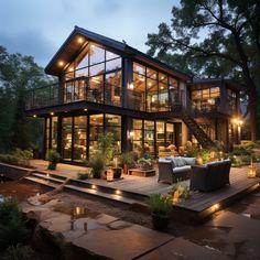 a large house with lots of windows and lights on it's sides, in the evening