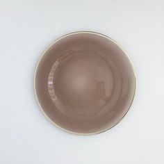 a brown plate sitting on top of a white table