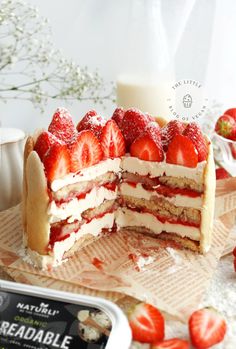 there is a cake with strawberries on the top and one slice cut from it