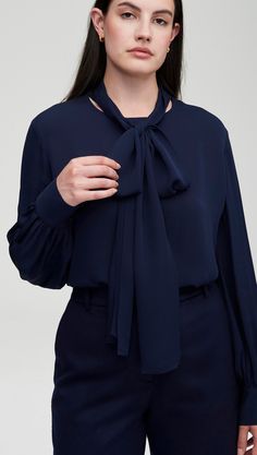 Made of airy Georgette silk, this elegant blouse features full blouson sleeves and an optional neck tie that can be knotted into a bow or wrapped like a scarf. Dress it up with a pant, or down to denim. Elegant Blouse With Gathered Sleeves For Night Out, Evening Blouse With Tie Sleeves, Evening Long Sleeve Blouse With Tie Sleeves, Evening Blouse With Long Tie Sleeves, Evening Blouse With Tie Sleeves And Long Sleeve, Elegant Top With Tie Neck And Sleeves, Silk Formal Blouse With Tie Sleeves, Elegant Long Sleeve Blouse With Tie Sleeves, Chic Blouse With Tie Sleeves And Neck