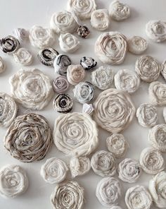 several different types of fabric flowers on a white surface