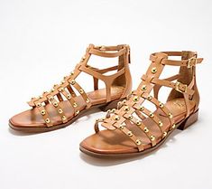 A timeless favorite, these gladiator sandals have a studded detail and two adjustable buckles, instantly elevating them to must-have status for all your summer looks. From Vince Camuto. Trendy Summer Sandals With Rivets, Spring Rivets Open Toe Sandals, Spring Open Toe Sandals With Rivets, Casual Summer Sandals With Rivets, Summer Sandals With Rivets And Round Toe, Casual Rivets Sandals For Spring, Summer Leather Sandals With Rivets, Leather Sandals With Gold Studs For Summer, Spring Beach Sandals With Rivets