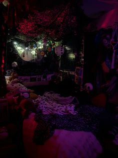 a bed room filled with lots of stuffed animals and decorations on the walls at night