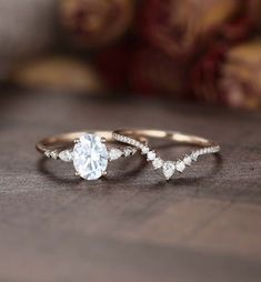 two gold rings with white diamonds on top