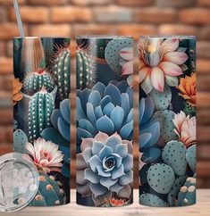 three travel mugs decorated with cactus and succulents on a wooden table