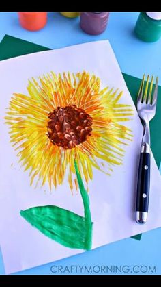 an art project for kids with watercolors and crayons on the table