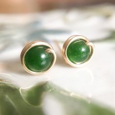 This beautifully simple stud earrings are is lovingly handmade with tiny Jade gemstones and a choice of a 14k Gold Filled, 14k Rose Gold Filled or Sterling Silver finish. M A T E R I A L S: * Dark Green Jade * 14k Gold Filled, 14k Rose Gold Filled or Sterling Silver S I Z E: * Gemstone - Approximately 4mm * Post Thickness - 0.8mm All of our jewellery is carefully handmade using good quality materials and handpicked gemstones, with the aim to produce quality pieces that you can love & wear for ye Simple Silver Earrings, Silver Wire Earrings, Silver Heart Earrings, White Jewelry Box, Simple Stud Earrings, Earrings Wire, Dainty Studs, Wire Wrapped Earrings, Gemstone Studs