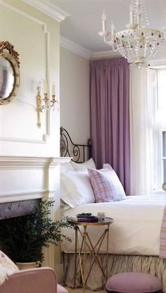 a bedroom with a bed, chair and chandelier in it's center