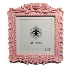 a pink frame with flowers and a fleur de lis design on the front