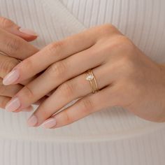 a woman's hand with a ring on her finger